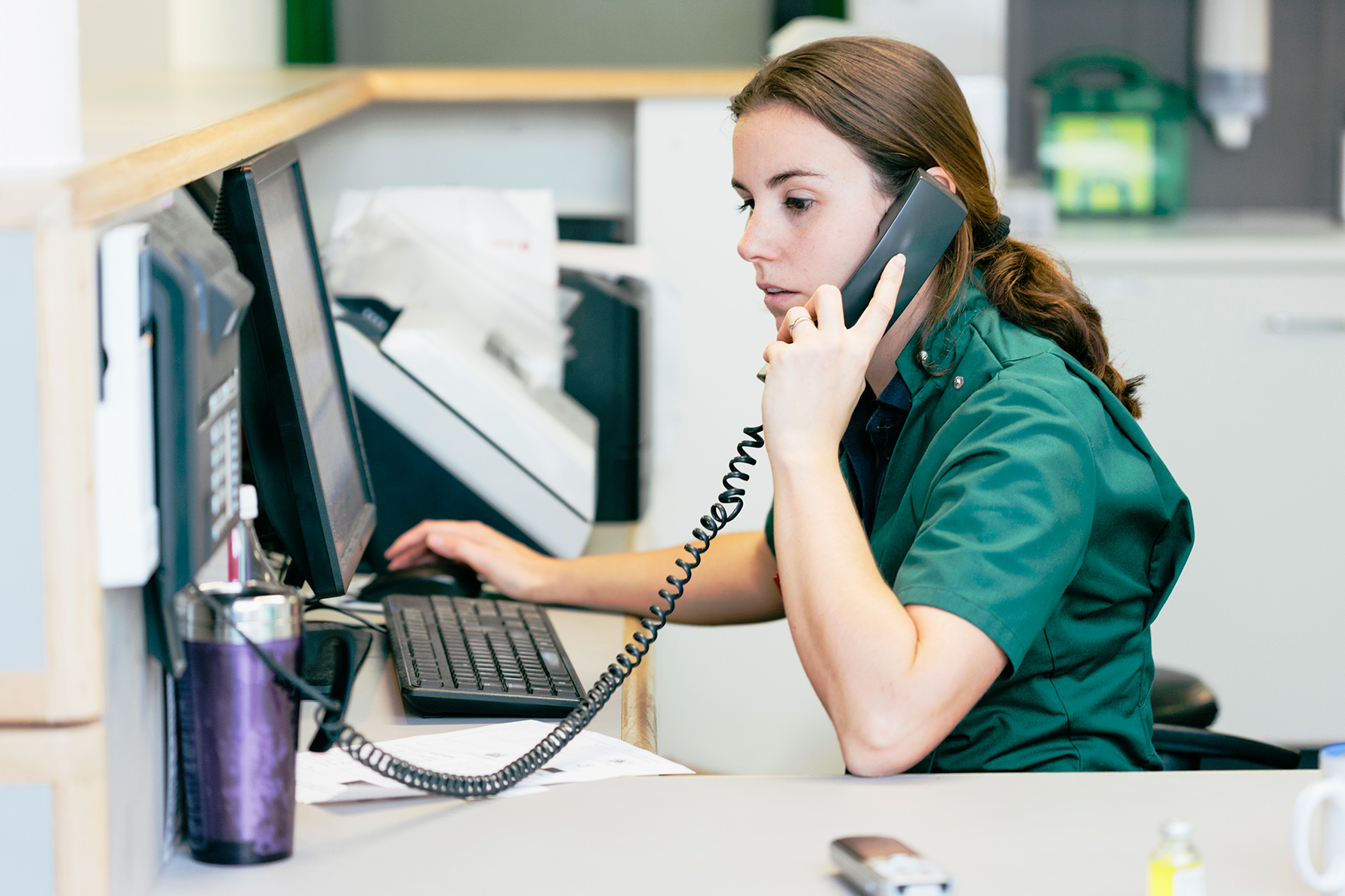 women in vet clinic talking on the office phone