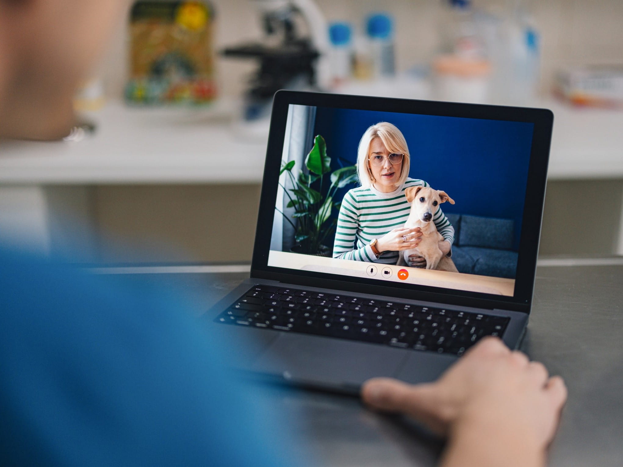 Woman with dog on telemedicine appointment with veterinarian