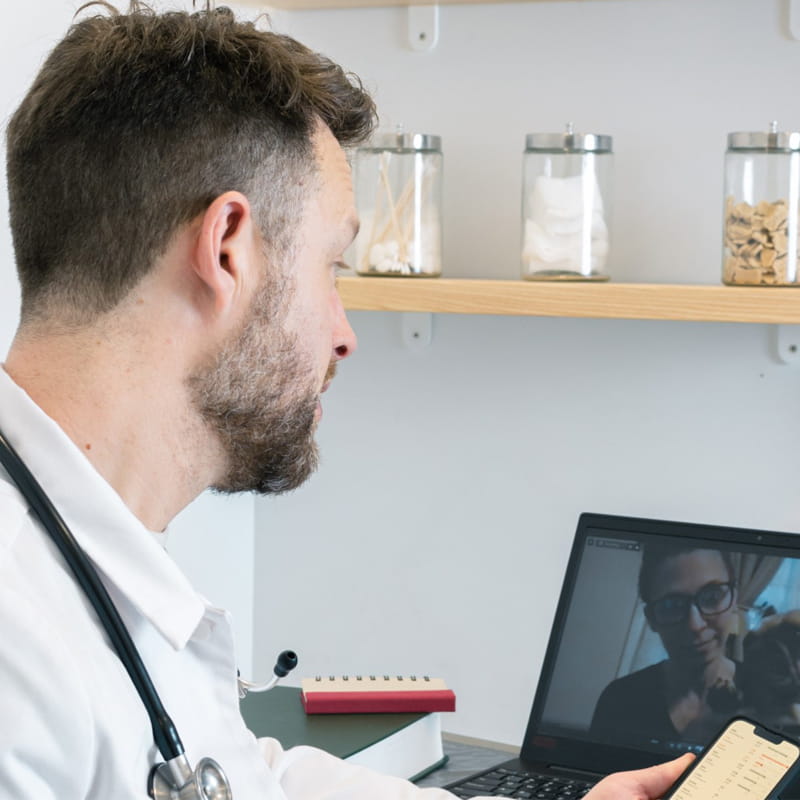 male veterinarian talking to patient virtually
